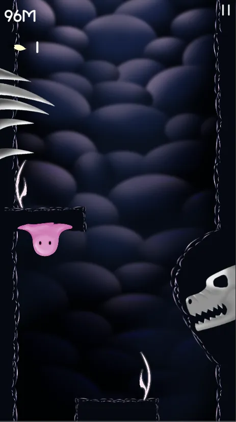 A pink ghost on a ledge beside a skull in the cave wall.